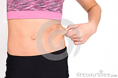 Slim young girl waist isolated on white background. Female person body in sportswear have calories loss and fat loss. Health and Stock Photo