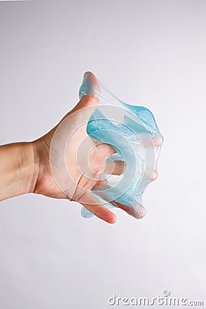 Slime glue a toy for children mucus and liquid flowing on hand Stock Photo