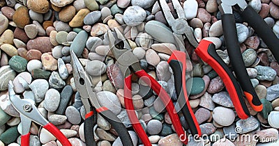 Slip Joint Pliers, Groove Pliers, Needle Nose Pliers And Linesman Pliers Laid Out Arranged On Size On A Stones Background Stock Photo