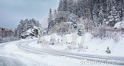 Slipery country road in snowy forest in winter. No cars. Stock Photo