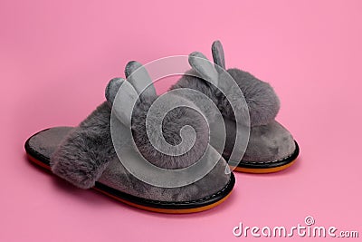 Slippers with fluffy ears, comfortable women`s home shoes on a pink background Stock Photo