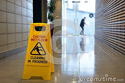 Slippery floor surface warning sign and symbol on a wet floor Stock Photo