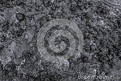 Slippery frozen earth covered ice. Winter black ground after freezing rain Stock Photo