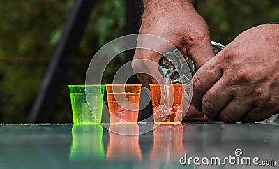 Slipping pÃ¡linka into little glasses 2. Stock Photo