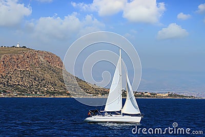 Sloop sailboat on a quiet sea in open waters. Editorial Stock Photo