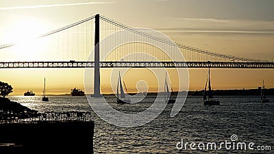 Sloops head for the Atlantic passing under the Ponte 25 de Abril over the Tagus River Stock Photo