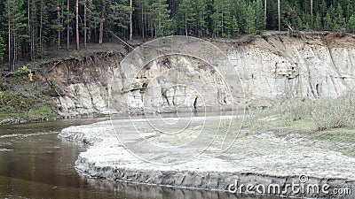 The slope of the clay Bank of the river with spruce forest and erosion of sand. Stock Photo