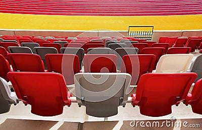 seating area detail of sport Stadium. curving rows of colorful plastic seats on steel frame. Stock Photo