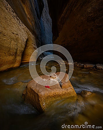 Slot Canyon Closes Over Single Boulder In Virgin River Stock Photo