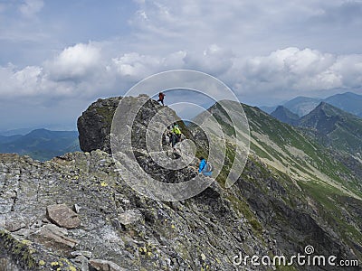 Slovakia, Western Tatra mountain, Rohacska dolina, July 2, 2019: Peope climbing on the hiking path on ridge of rohace Editorial Stock Photo