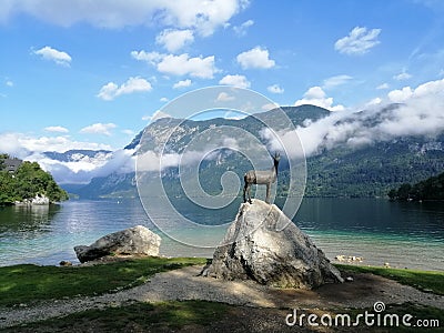 Slovenia, Bohinj lake, chamois statue on rock, early in the morning Stock Photo