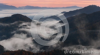 Slovenia, Somewhere Near Famous Place Jamnik. Magical Morning Misty Gradients. Fog Seeping Through The Trees And Hills.Foggy Mount Stock Photo