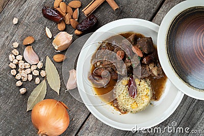 Slow cooked lamb with potato and dates served with warm couscous and chickpeas Stock Photo