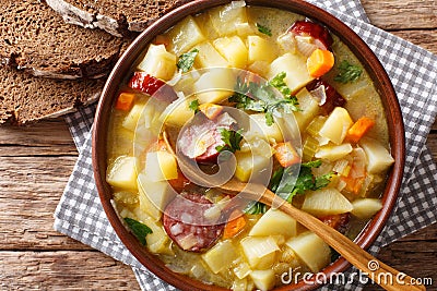 Slow cooker German potato soup kartoffelsuppe close-up on a pl Stock Photo