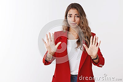 Slow down take easy. Girl restraining giving negative reply raising extended palms refusal, stop gesture asking control Stock Photo