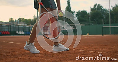 Slow-motion side view of a young athlete trains the serve of the tennis ball. A teenage athlete is playing tennis on a. Court. An active girl is powerfully stock video Slow-motion side view of a young athlete trains the serve of the tennis ball. A teenage athlete is playing tennis on a. Court. An active girl is powerfully stock video
