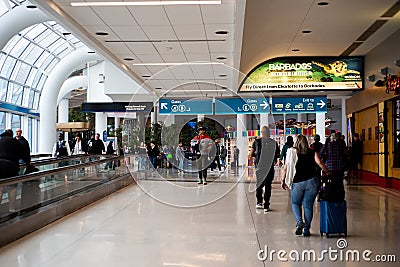 Slow-moving conveyor or autowalk with diverse group passenger traveler inside Charlotte Douglas International Airport, multiethnic Editorial Stock Photo