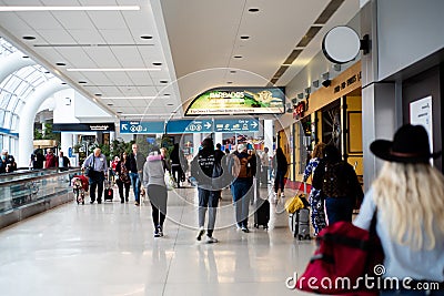 Slow-moving conveyor or autowalk with diverse group passenger traveler inside Charlotte Douglas International Airport, multiethnic Editorial Stock Photo