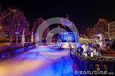 Night scenery at ice rink with people enjoy ice skating at Heumarkt, famous Christmas market square in KÃ¶ln. Editorial Stock Photo