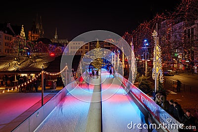 Night scenery at ice rink with people enjoy ice skating at Heumarkt, famous Christmas market square in KÃ¶ln. Editorial Stock Photo