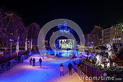 Night scenery at ice rink with people enjoy ice skating at Heumarkt, famous Christmas market square in KÃ¶ln. Editorial Stock Photo