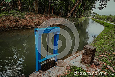 Sluice gate to regulate irrigation water discharge Stock Photo