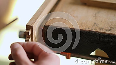 Sluiten. een joiner snijdt een dovetail-verbinding in een eikenplank met een houtsnip. carpentry kraftsmanship handicrafts. de gel stock videobeelden Sluiten. een joiner snijdt een dovetail-verbinding in een eikenplank met een houtsnip. carpentry kraftsmanship handicrafts. de gel stock videobeelden