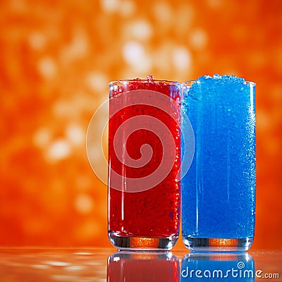 Slush ice in glasses, red and blue on glitter star background Stock Photo