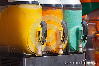 Slush machines with 3 colorful flavored frozen drinks ready to be served Stock Photo