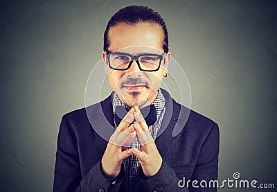 Sly business man in glasses looking at camera Stock Photo