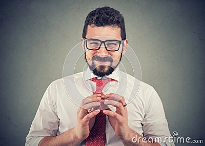 Sly businessman in glasses looking at camera plotting a revenge Stock Photo