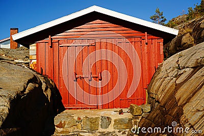 Smal red boat house at the harbor, Norway Stock Photo