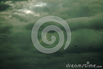 Small airplane against stormy sky Stock Photo