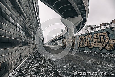 Small alley under the highway. Graffiti on the walls. Editorial Stock Photo