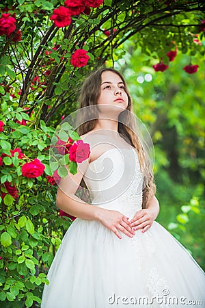 Small angel for bride. cute lady. happy childhood. beauty and fashion. pretty kid smell rose flower. spring and summer Stock Photo