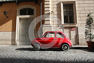 Small Antique Car parked on cobble stone road Editorial Stock Photo