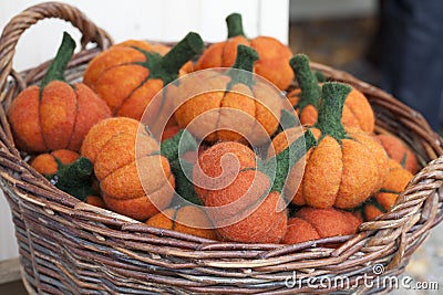 Small artificial pumpkins made of felt in a basket Stock Photo