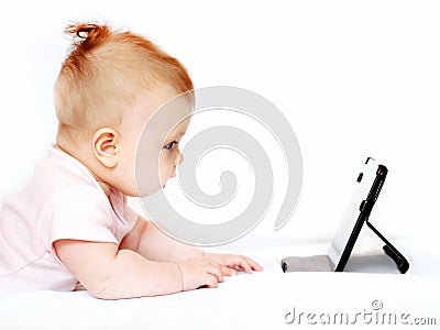 Small baby using tablet pc on white Stock Photo