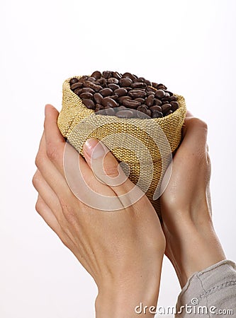 Small bag of coffee beans in female hands Stock Photo