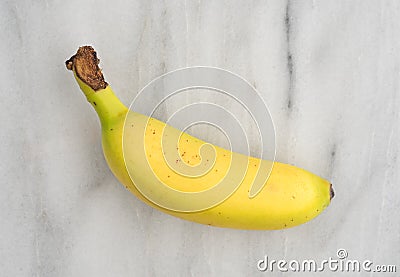 Small banana on a marble cutting board Stock Photo