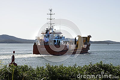 Small barge motoring out of Gladstone harbour. Editorial Stock Photo