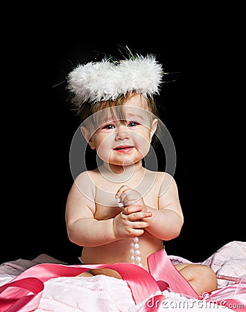 Small beautiful baby girl in a angel fansy dress Stock Photo
