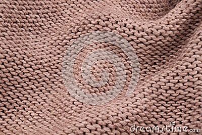 Small beautiful folds on a warm knitted wool blanket in beige Stock Photo