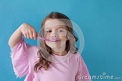 Small beautiful girl cleans teeth toothbrush Dentistry Stock Photo