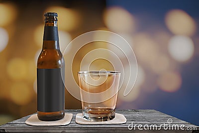 Small beer bottle with a glas on a table with a blur bokeh Stock Photo