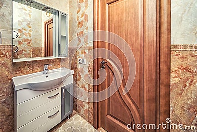 Small beige tile bathroom with sink and mirror Stock Photo