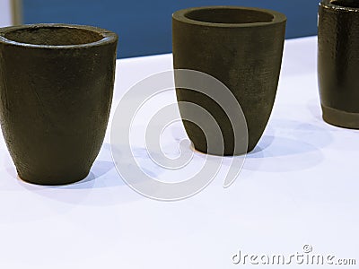the small black ceramic crucible for transfer molten metal into mold Stock Photo