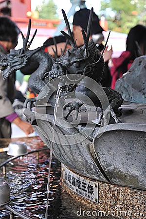 Small black dragon sculpture fountain in Sensoji temple in Asakusa, Japan Editorial Stock Photo