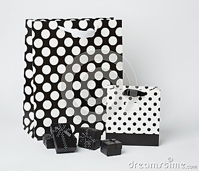 Small, black gift-boxes with black and white gift-bags with polka dots. Stock Photo