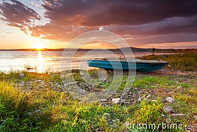 Small blue boat by the lake Stock Photo